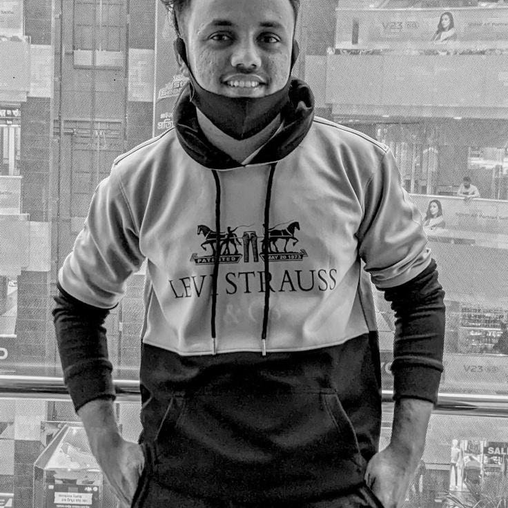 Aisha Patel, Lead Design Curator at DawnRippleField, reviewing corporate floral arrangements